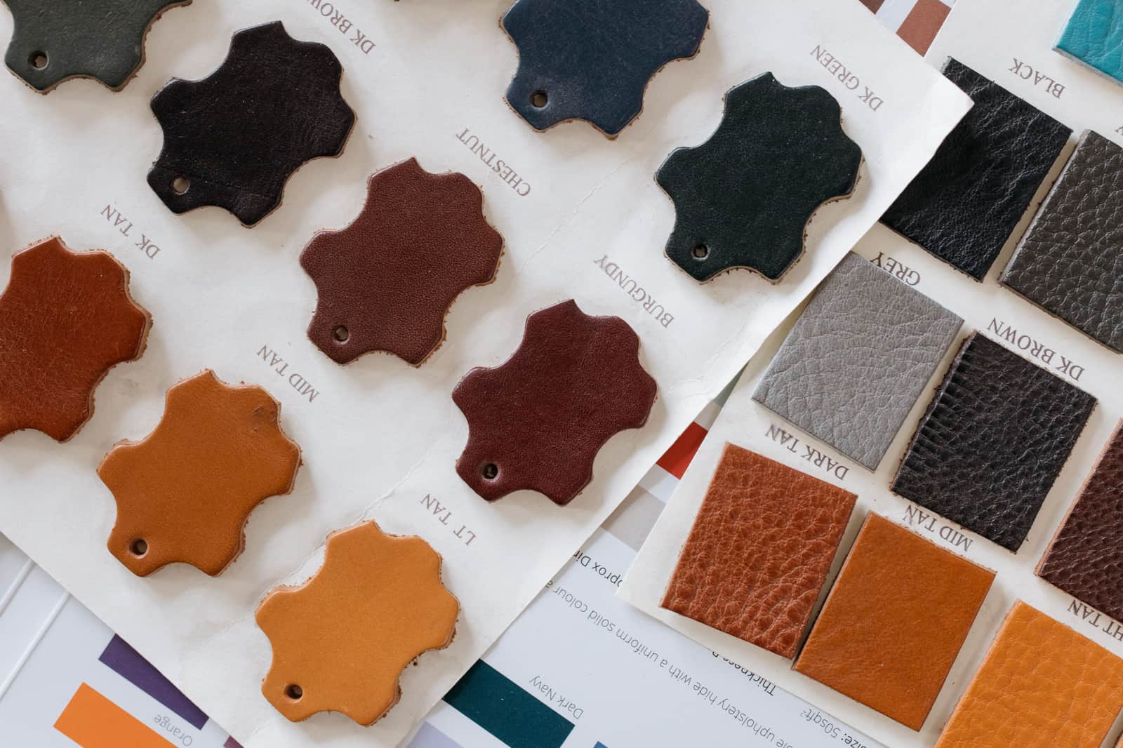 Stacked swatches of leather in tan and brown showing different grains